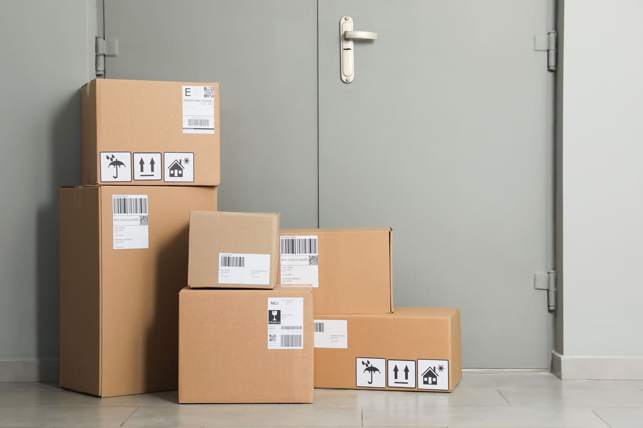 IMG_5127 Stacked delivery boxes outside a door, illustrating the growing demand for scalable package management solutions during the holiday season in multifamily communities.