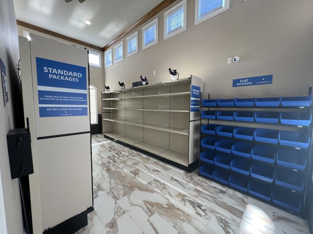 Organized Smart Package Room system with labeled standard and flat package areas, showcasing efficient mailroom organization ideas for multifamily buildings.